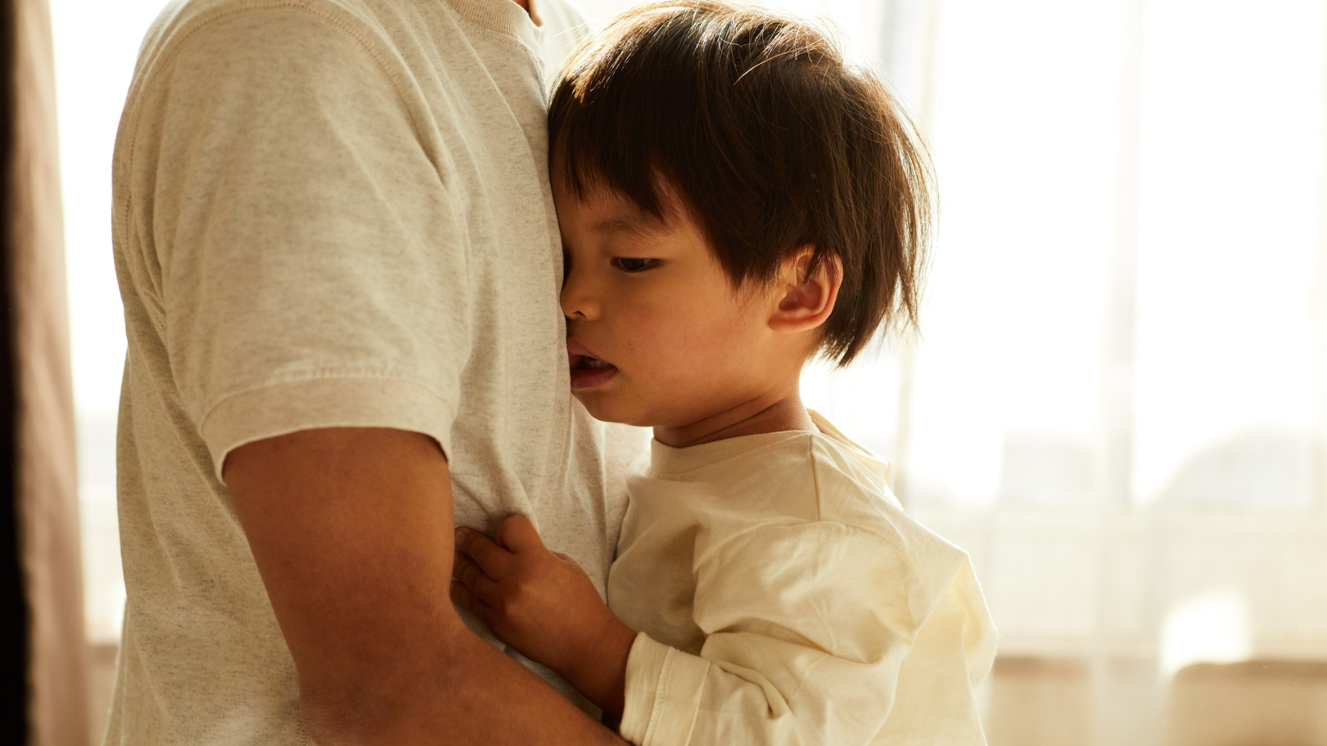 When access to care means everything to a child Child hugging an adult closely, looking anxious