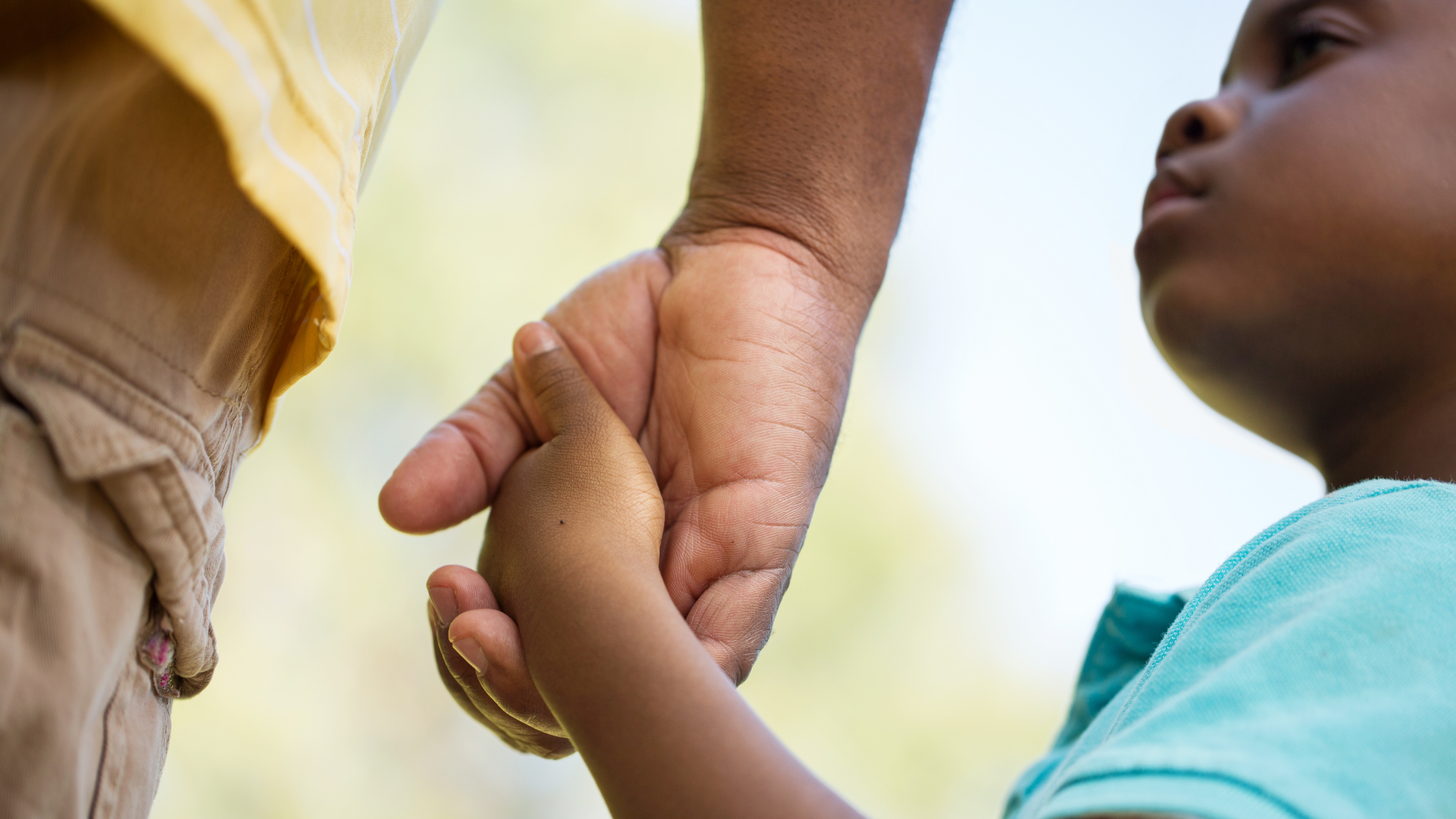 Holding on for hope in New Mexico’s healthcare crisis Child holding hands with a parent for reassurance